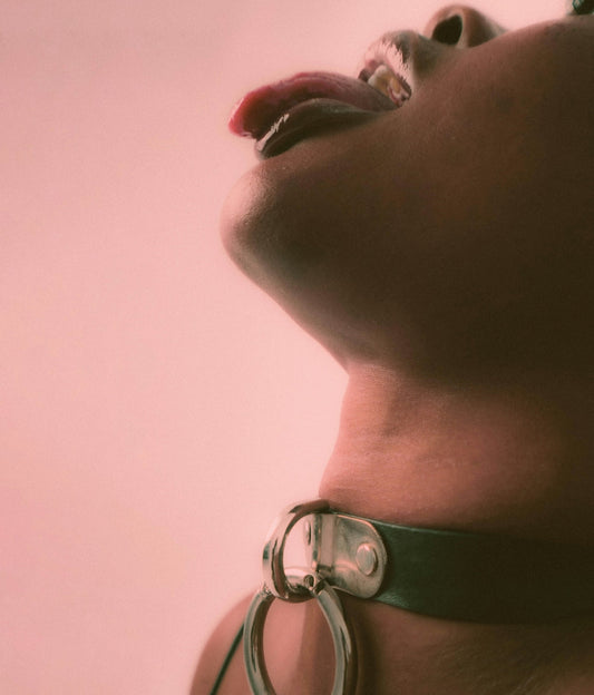 a close up of a person wearing a choker